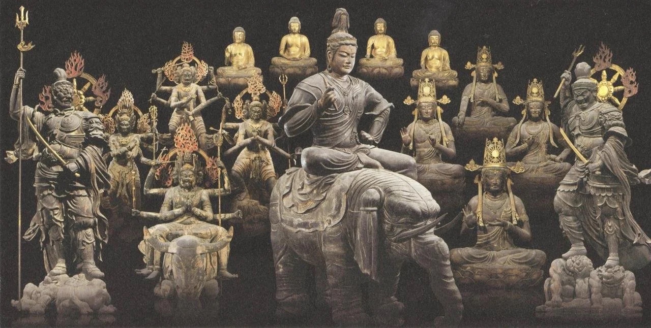 Rows of bronze Buddhist statues in shadow.