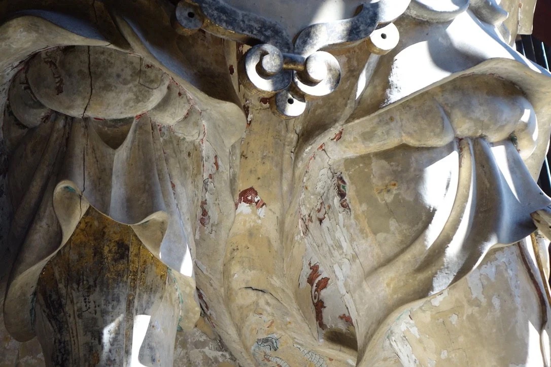 Guardian statue seen from below.