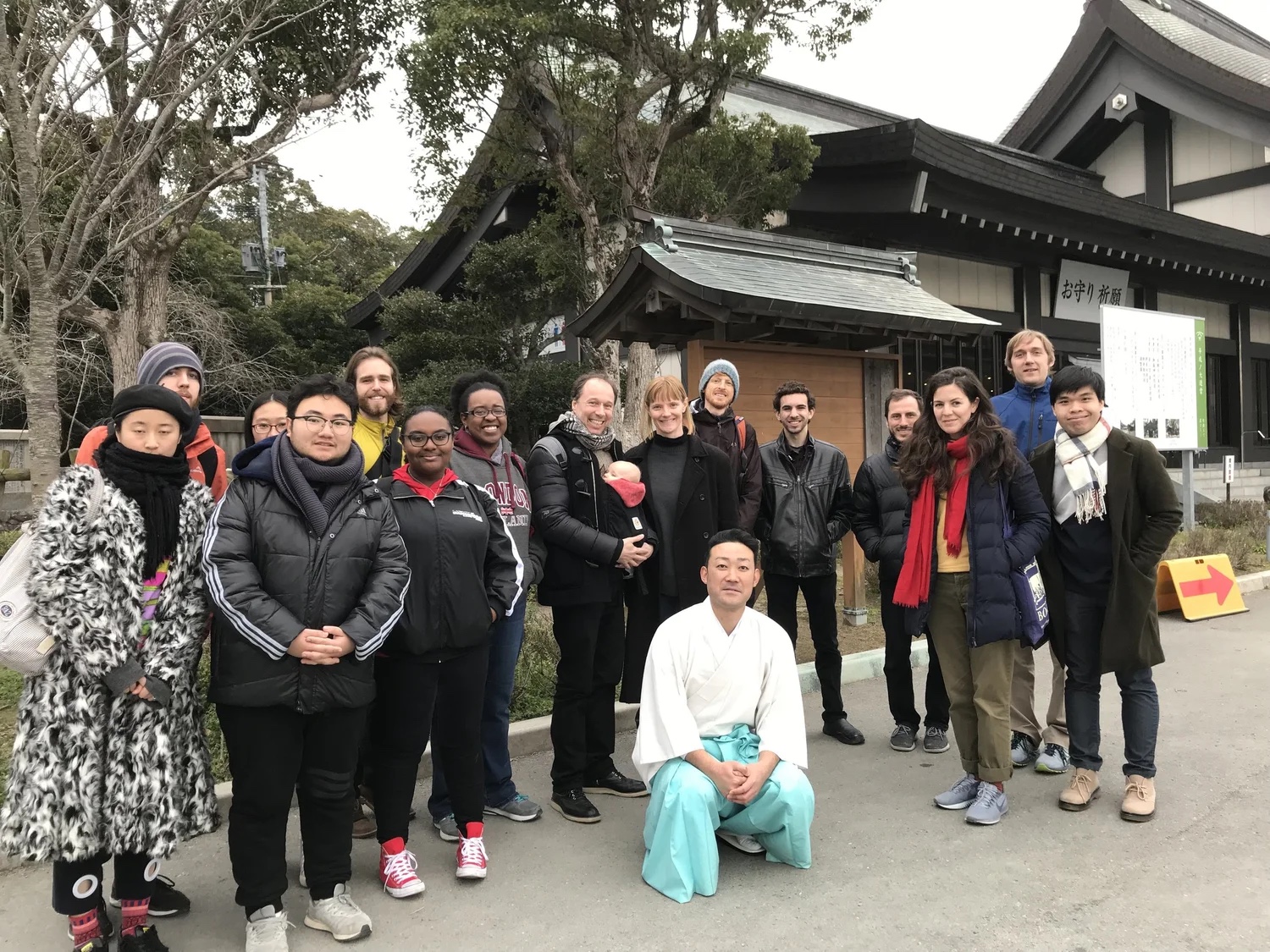 Course group photo outside a temple gate.
