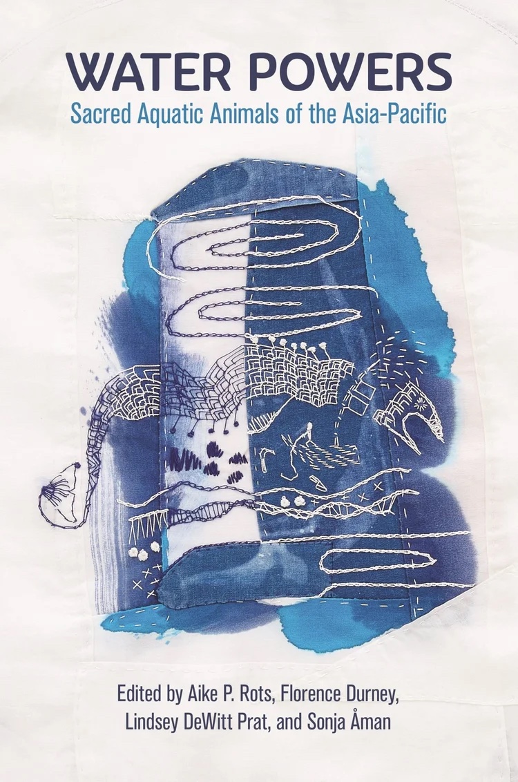 Cover of Water Powers: Sacred Aquatic Animals of the Asia-Pacific, an indigo textile artwork with embroidered aquatic creatures on white cloth.