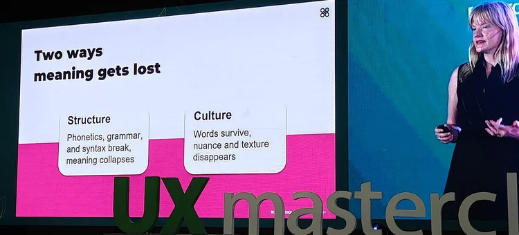 Lindsey on a masterclass stage beside a large slide titled Two ways meaning gets lost, contrasting structure and culture.